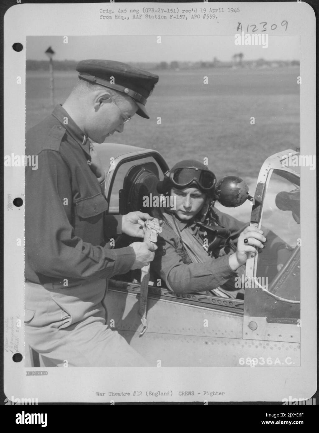 Seated In The Cockpit Of His Fighter Plane, The Pilot Is Instructed By