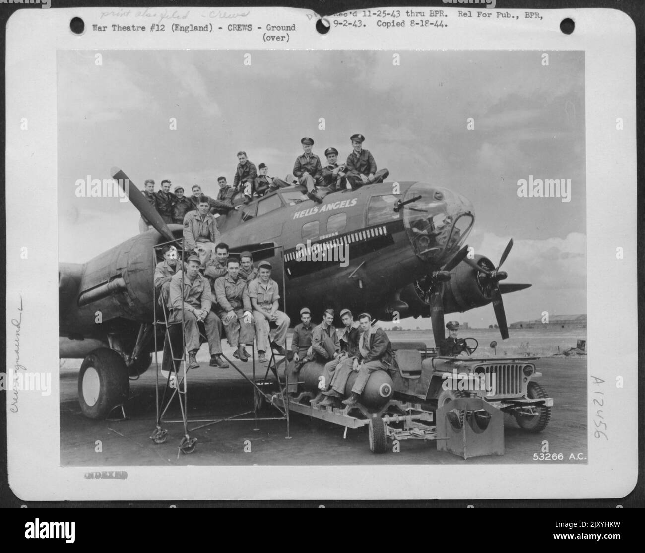 The air crew, ground crew and armourers of 'Hell's Angels,' a Boeing B-17 Flying ofrtress, operating from England. Major Kirk R. Mitchell, Oklahoma City, Oklahoma, Commanding Officer of the Squadron is in the jeep. The quiet looking little job on Stock Photo