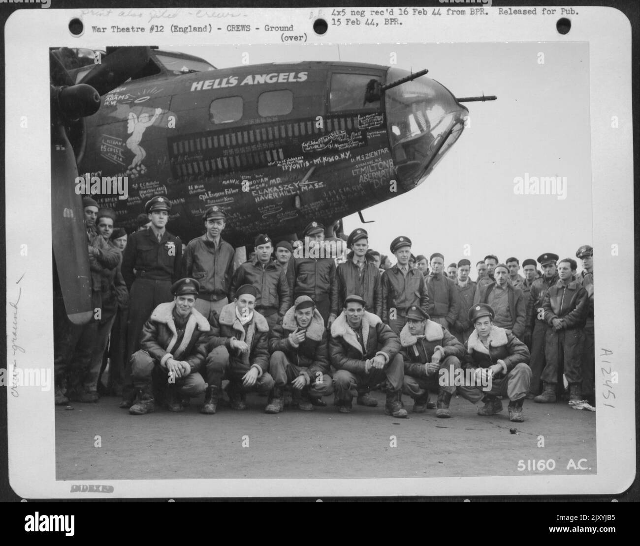 England-Crew of Boeing B-17 'Hell's Angels' by nose of ship. Kneeling left to right, Ground Crew: oflmer, West, Kosilla, Wegrzyn, Fairfield, Touhey. Standing-Flight Crew; Johnson, DeCamp, McElwain, McCord, Zeller, Briggs. Stock Photo