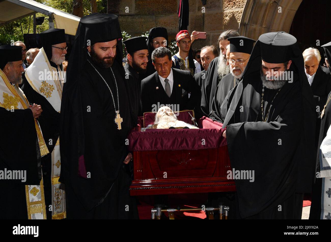 Greek Orthodox priests carry out the coffin during the funeral of Greek