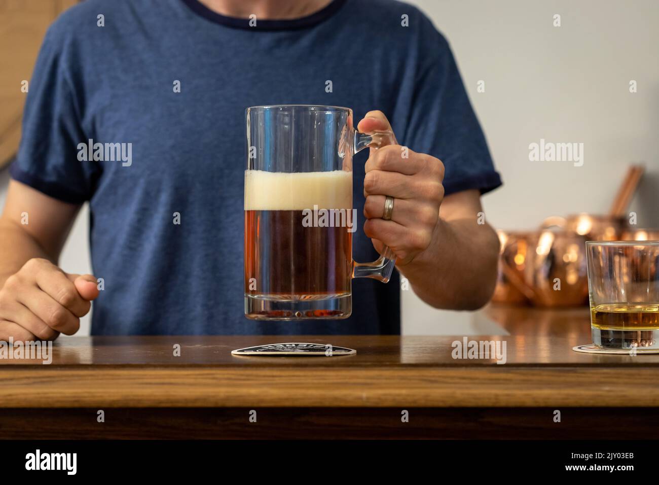 Man Drinking Beer from a Stein Glass at a Bar Stock Photo Alamy