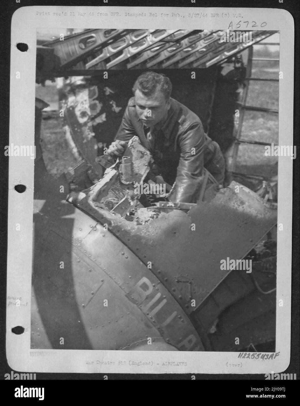 1St Lt. Elbert F. Lonzes Of New Orleans, La., Bombardier, Scrutinizes The Bomb Salvo Handles Which He Found In The Melted Wreckage Of His Ship, The Consolidated B-24 Liberator 'Vadie Raye.' After A Successful Attack On Hamm, Germany, 22 April 44, The Lib Stock Photo