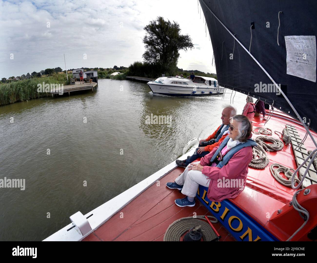 passengers sailing on board vintage sailing wherry albion on river thurne, norfolk england Stock Photo