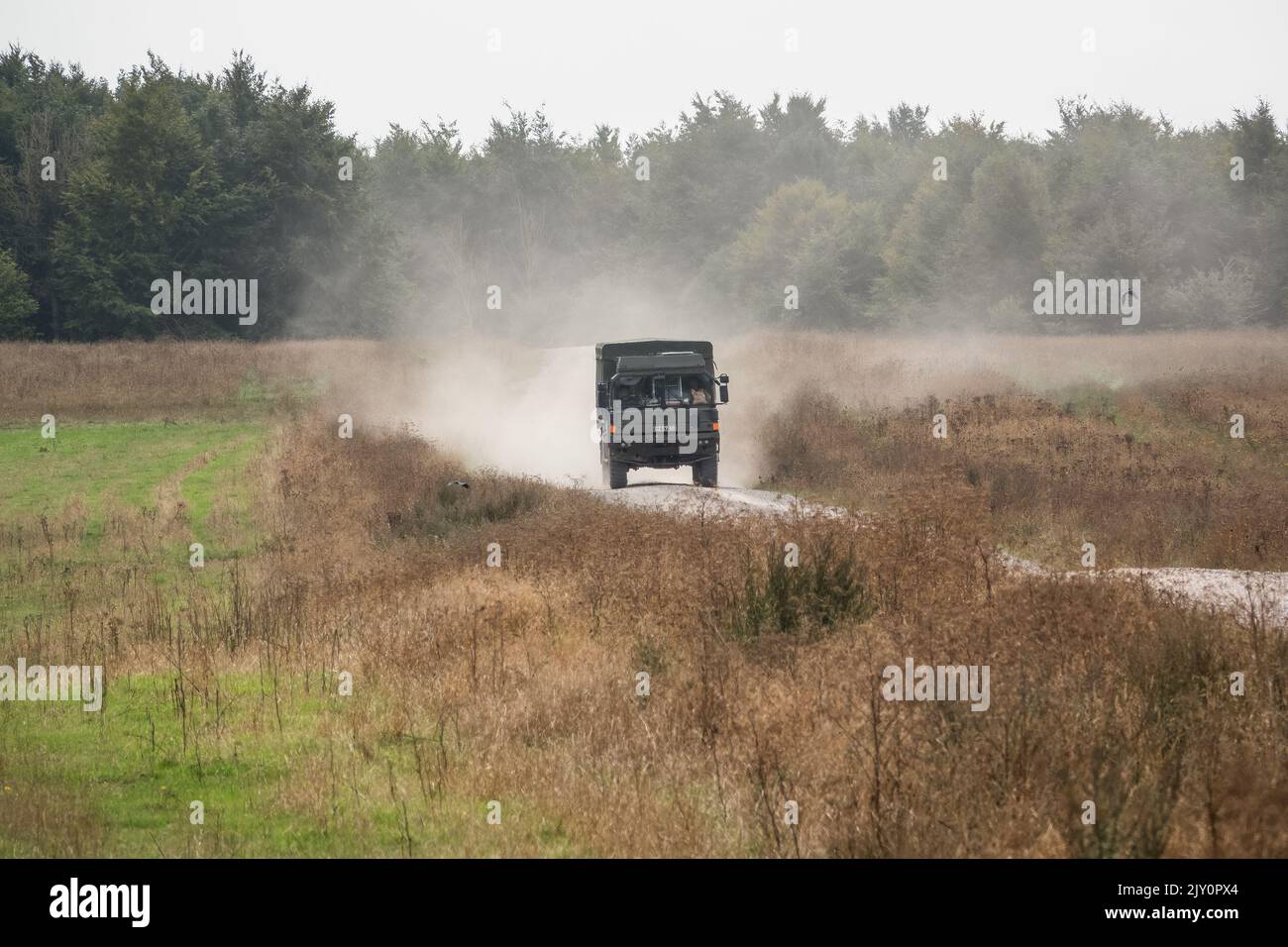 British army MAN SV HX60 4x4 logistics truck crossing open countryside in action on a military exercise Stock Photo