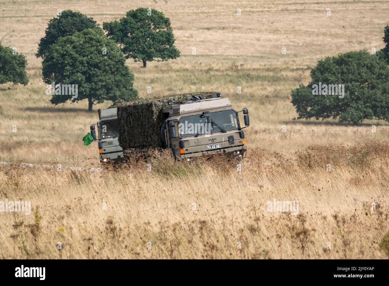 British army MAN HX60 4x4 Heavy Utility Trucks in action on a military exercise Stock Photo
