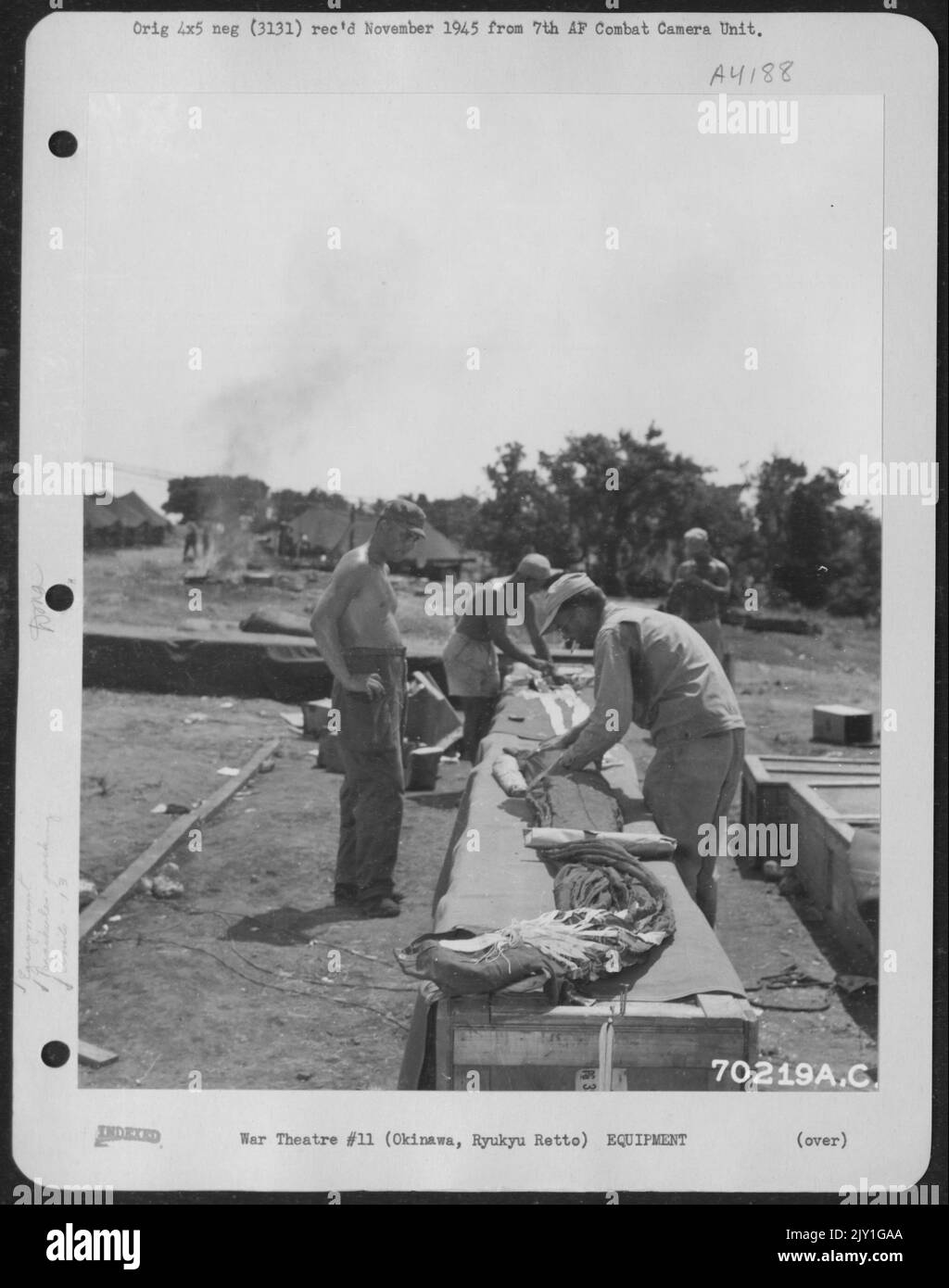 A Cargo Parachute Of The 13Th Air Cargo Re-Supply Squadron Is Laid Out Before It Is Rolled Up For Packing By Men Of The 7Th Air Force At The Edge Of Kadena Air Field On Okinawa, Ryukyu Retto. 17 August 1945. Stock Photo