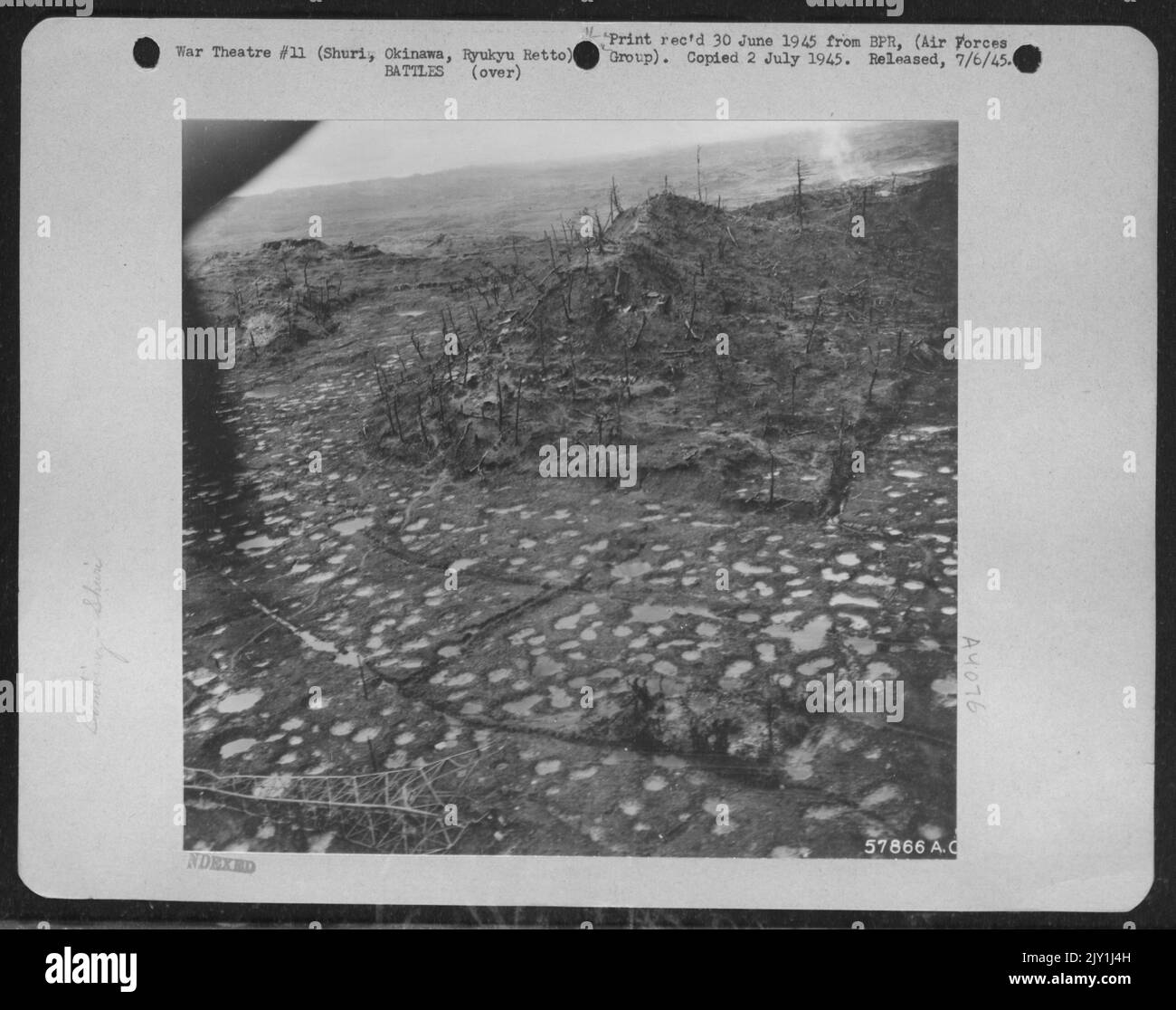 In The Wake Of War - This Polka-Dot Pattern Of Rain Filled Shell Holes And The Splintered Stumps Of Leafless Trees On An Okinawan Hillside Attest To The Deluge Of Tenth Army Artillery Poured On Strong Japanese Positions Around Shuri Castle. The Demolished Japanese Stock Photo