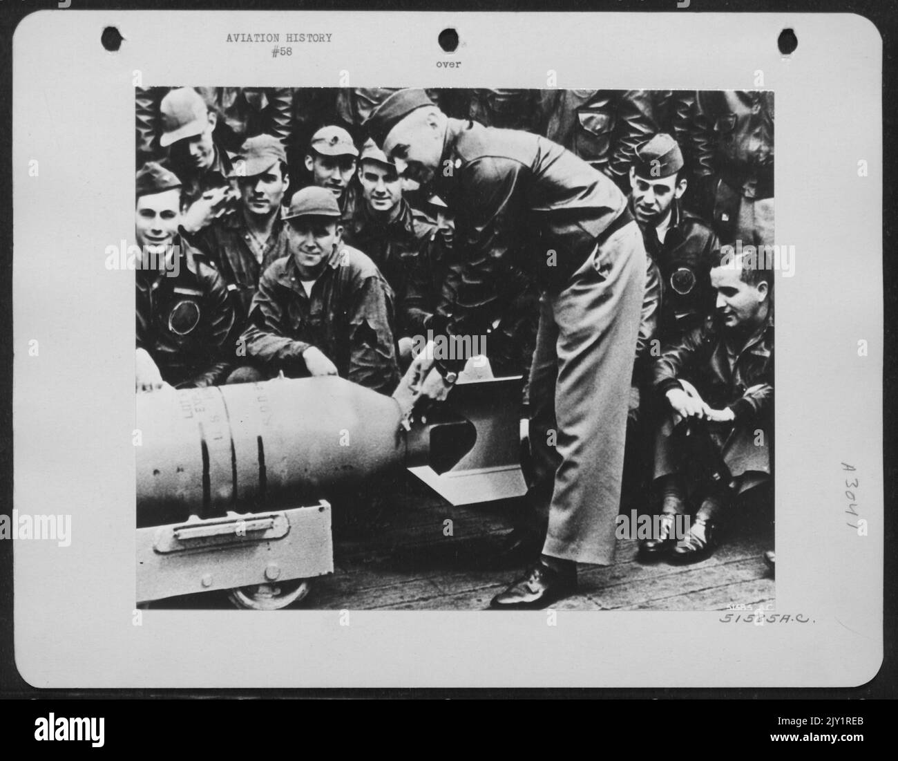 Maj. Gen. (Lt. Col. Then) James H. (Jimmy) Doolittle, U.S.A. wires a Japaneseanese medal to the fin of a 500 lb. bomb which shortly thereafter was returned to its Nipponese makers in a blast of destruction. The ceremony took place on the deck Stock Photo