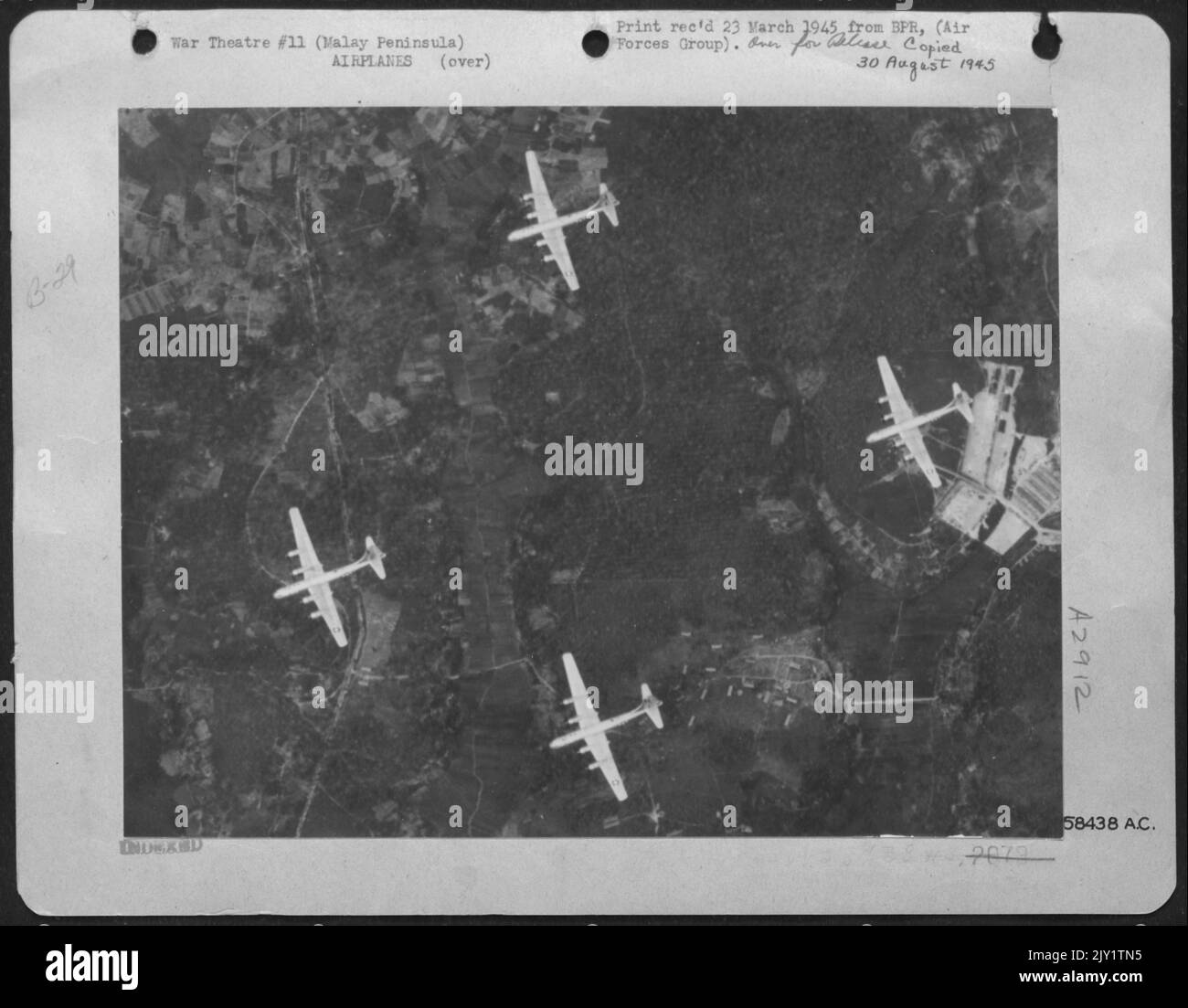 In A Mission Mounted From Bases In India, Boeing B-29S Of Brig. Gen Roger M. Ramey's 20Th Bomber Command Struck The Work Shop Area Of The Singapore Naval Base. Pictured Here Are Four Superfortresses Flying Over A Part Of The Important Japaneseanese-Held Stron Stock Photo