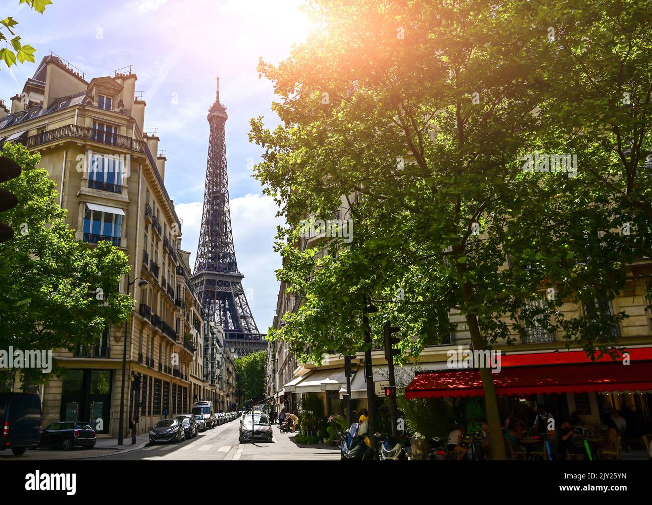 Paris, France. June 2022. Amazing shot of the Eiffel Tower rising between the buildings of the old town and the canopy of trees. Stock Photo