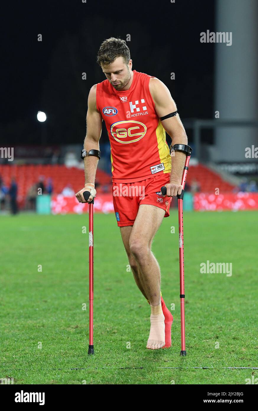 Jordan Murdoch of the Suns is seen on crutches following the Round 12 ...