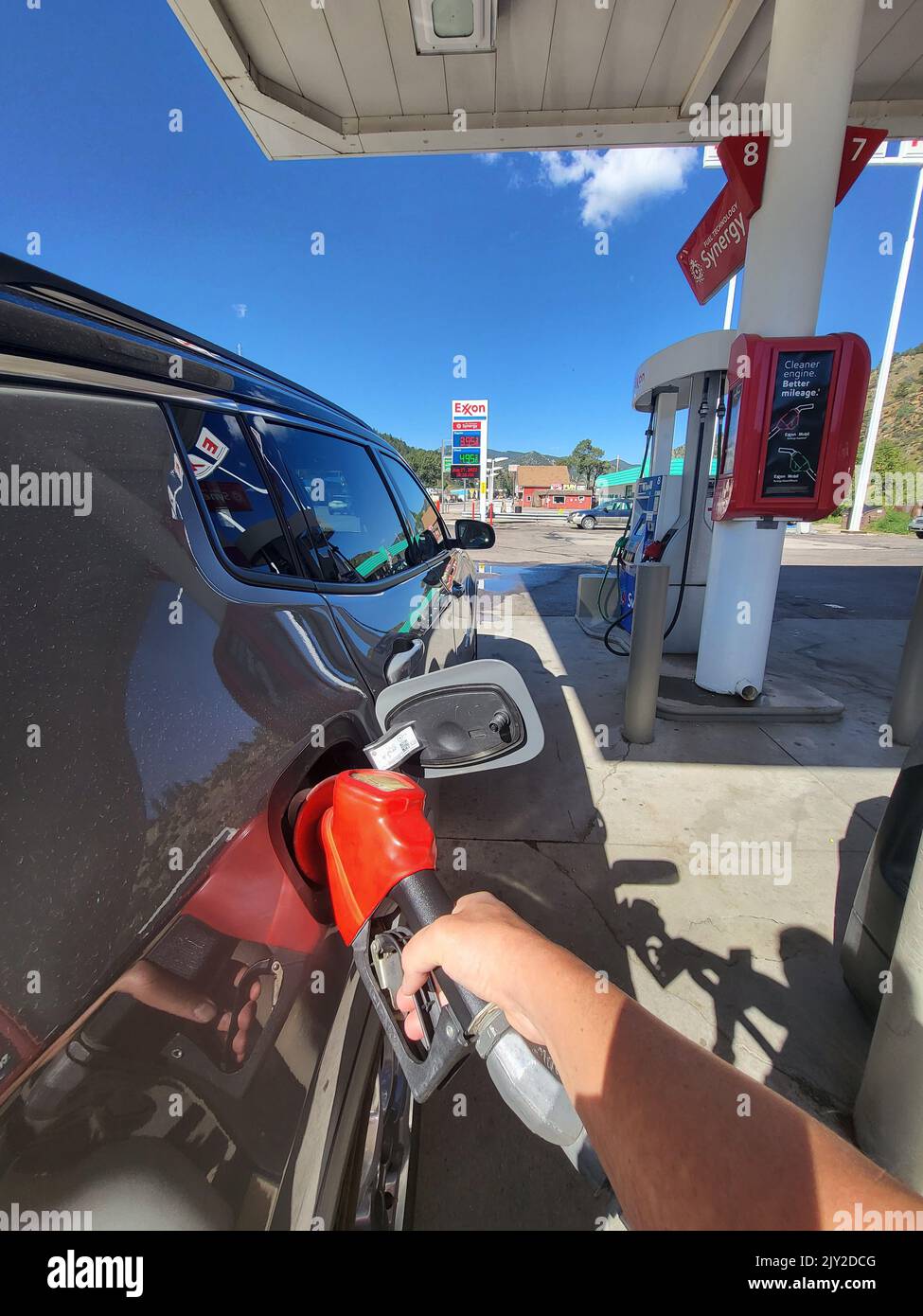 DENVER, CO - September 4, 2022: Refueling a car at Exxon Retail Gas Location. ExxonMobil is the World's Largest Oil and Gas Company. Stock Photo