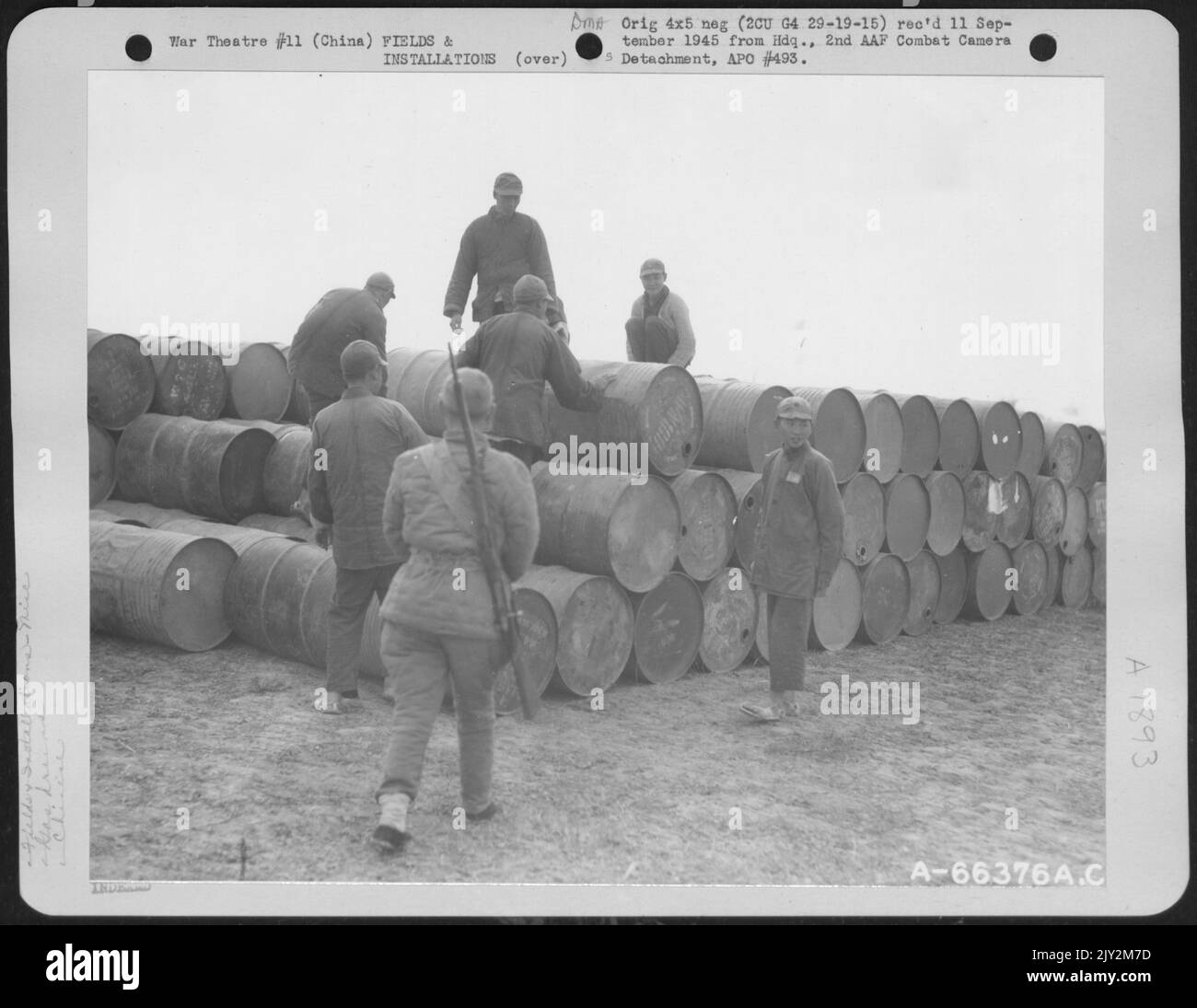 Chinese Coolies Stack Empty Gasoline Drums In A Large Pile The Fuel