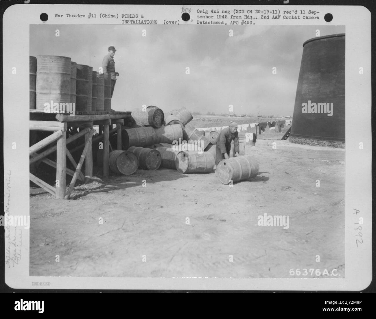 Chinese Coolies Stack Empty Gasoline Drums In A Large Pile The Fuel