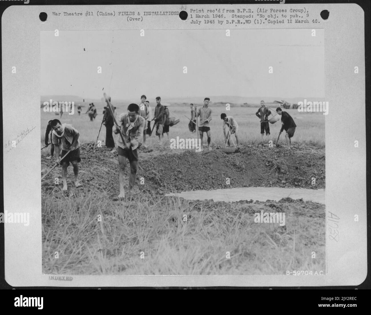 Four Days After The Japaneses Left The Nanning Airbase In China With Its Bomb Craters, Ditches And Landmines, The 14Th Af Aviation Engineers Had Rounded Up Close To A Thousand Coolies And By The End Of The Week The Ditches Were Filled And The Bomb Craters Neut Stock Photo