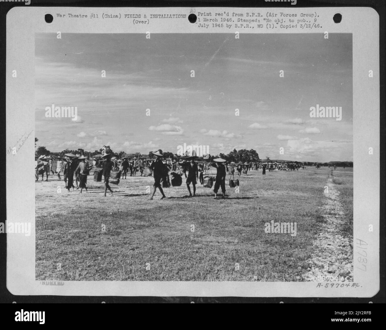 Four Days After The Japaneses Left The Nanning Airbase In China With Its Bomb Craters, Ditches And Landmines, The 14Th Af Aviation Engineers Had Rounded Up Close To A Thousand Coolies And By The End Of The Week The Ditches Were Filled And The Bomb Craters Neut Stock Photo