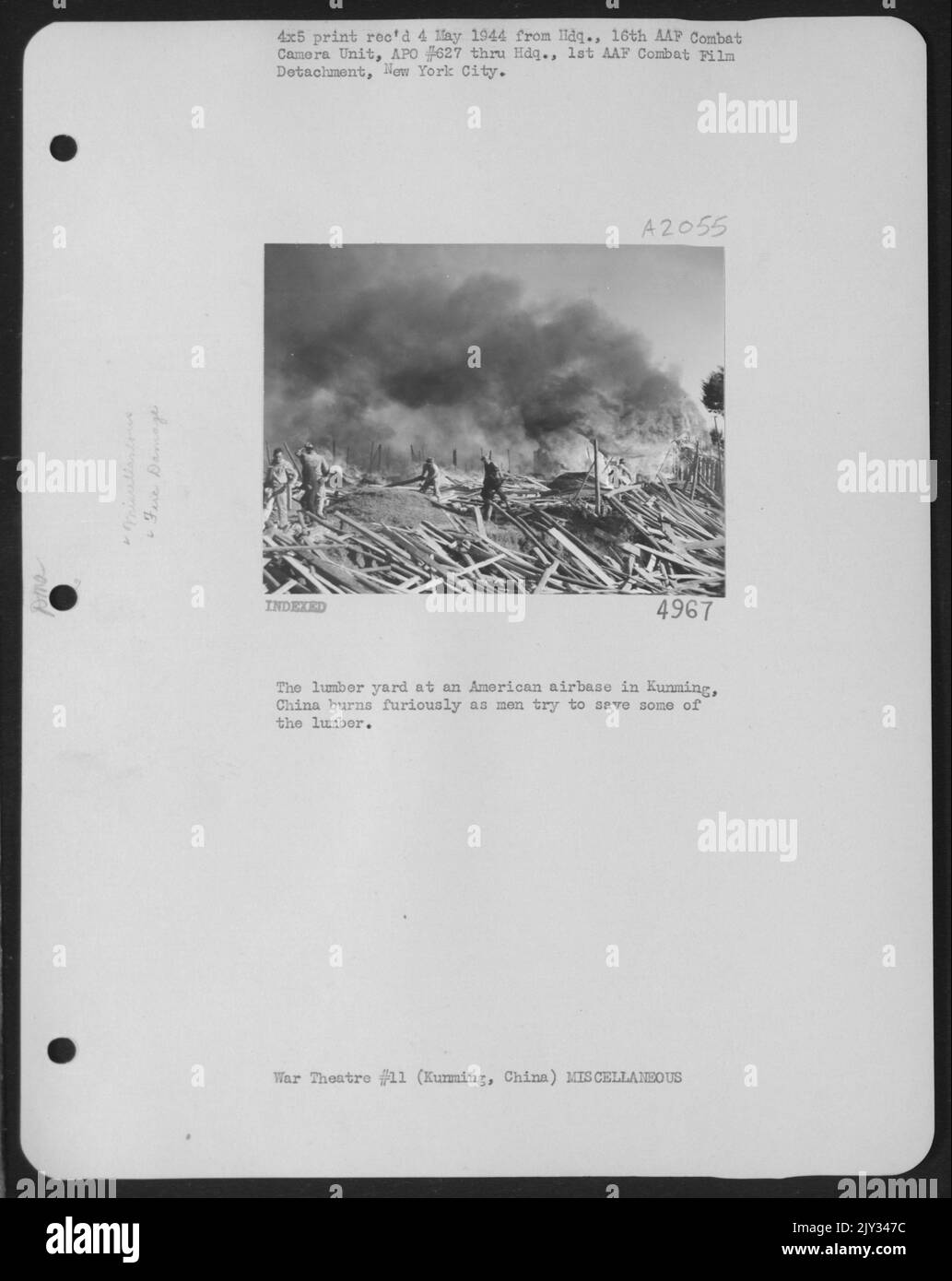 The Lumber Yard At An American Airbase In Kunming, China Burns Furiously As Men Try To Save Some Of The Lumber. Stock Photo