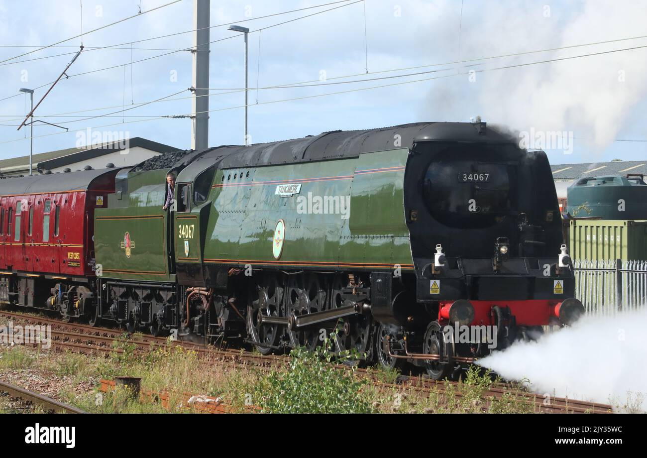 Battle of Britain class steam engine 34067 Tangmere with support coach backing on to the Northern Belle luxury train at Carnforth 7th September 2022. Stock Photo