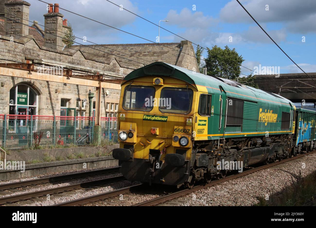 Freightliner heavy haul class 66 shed, number 66607, hauling a freight train along the West Coast Main Line through Carnforth on 7th September 2022. Stock Photo