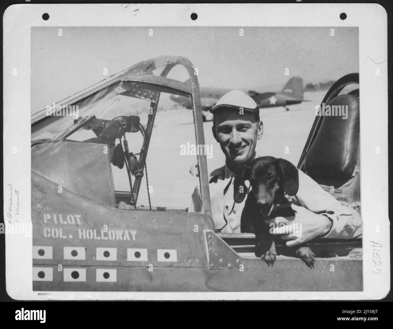 Colonel Bruce K. Holloway Is Shown With A Mascot In The Cockpit Of His