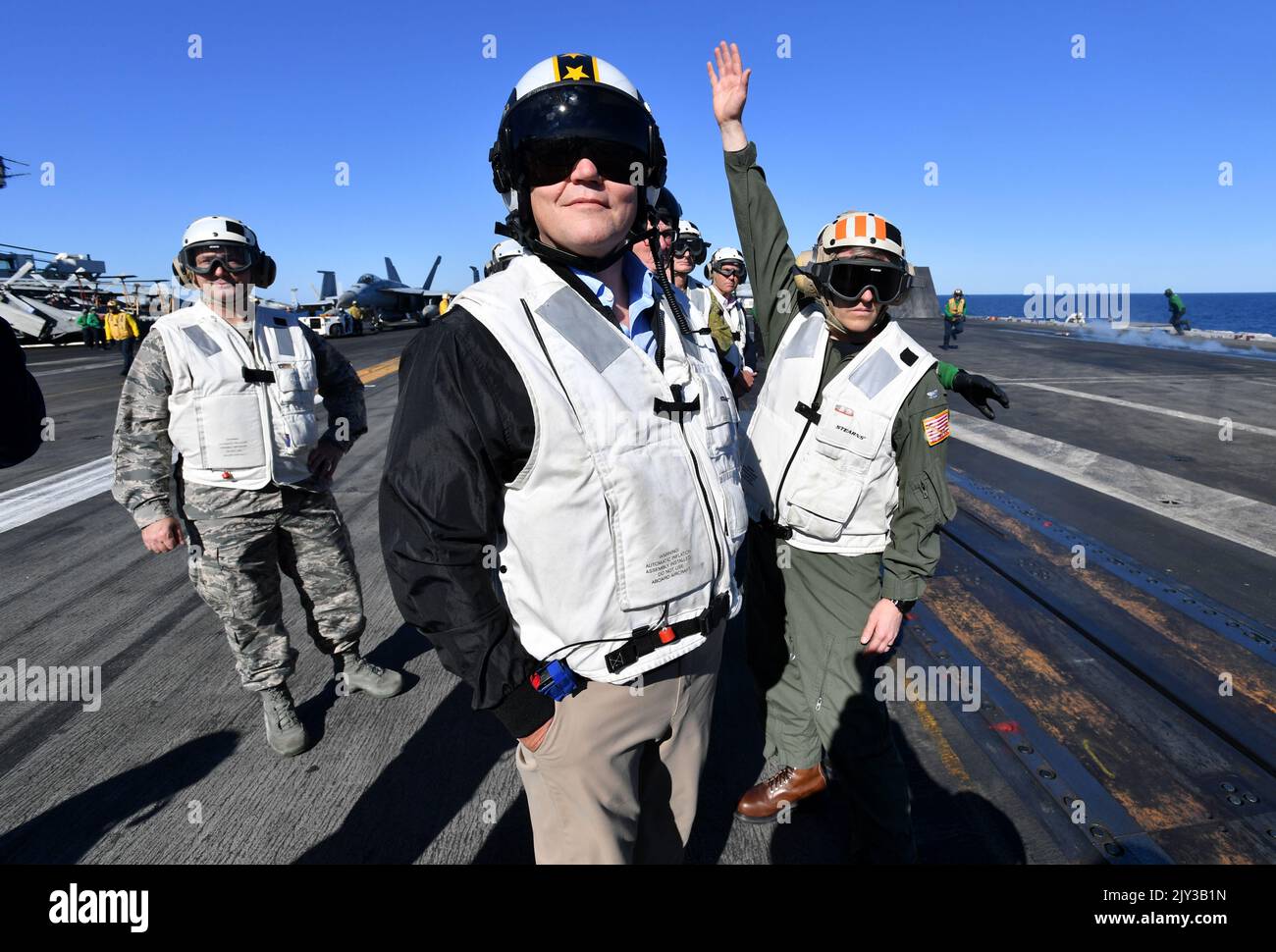 Australian Prime Minister Scott Morrison (centre) is seen on the flight ...