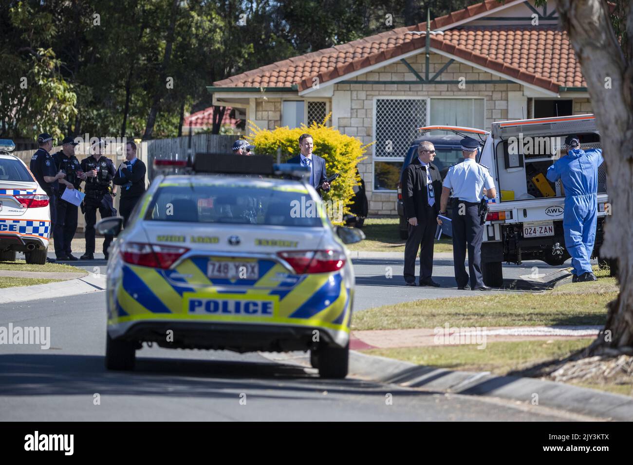 Police and forensic police are seen at a crime scene in Cassowary St