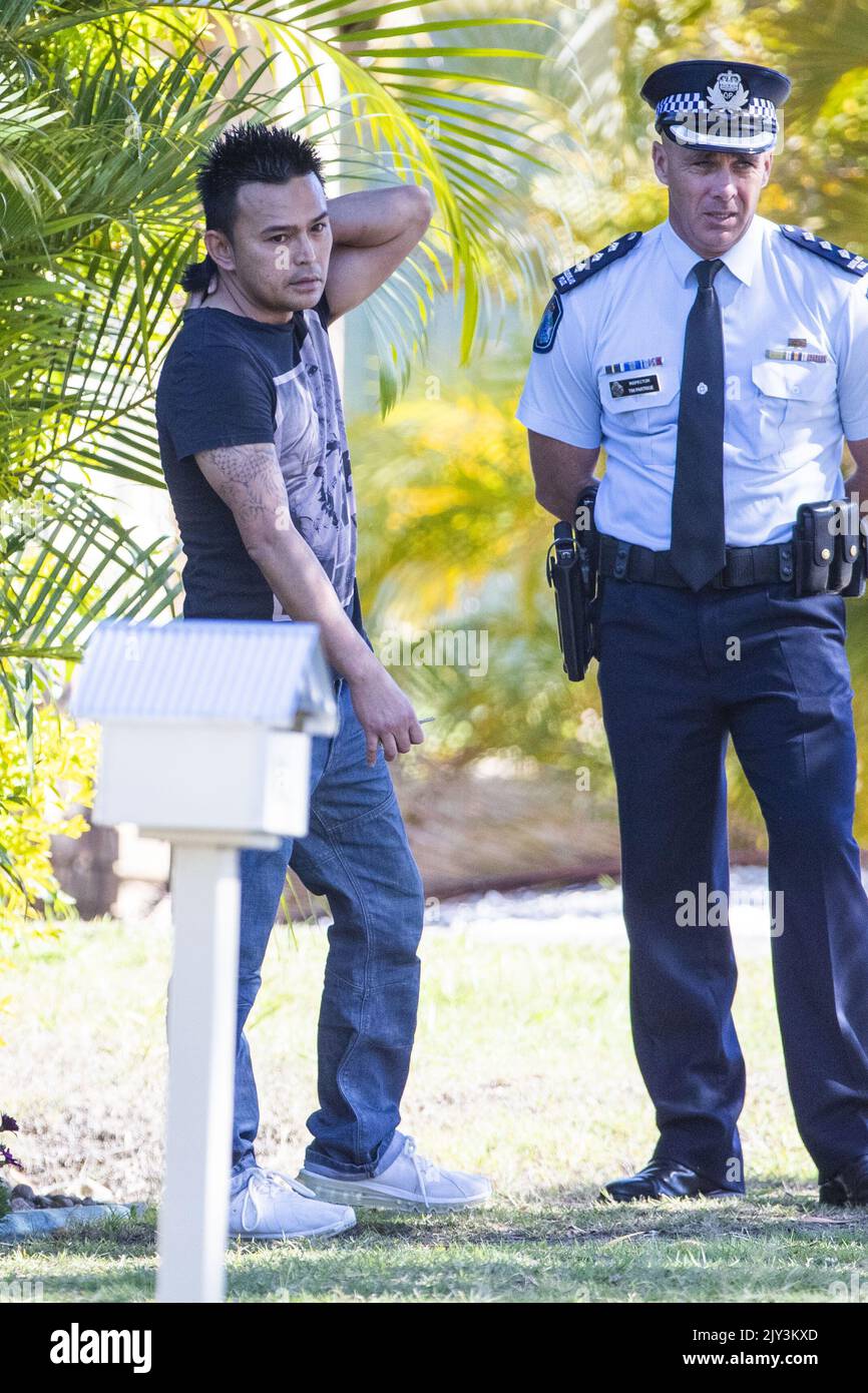 A relative of a man shot by police speaks to an officer at the crime