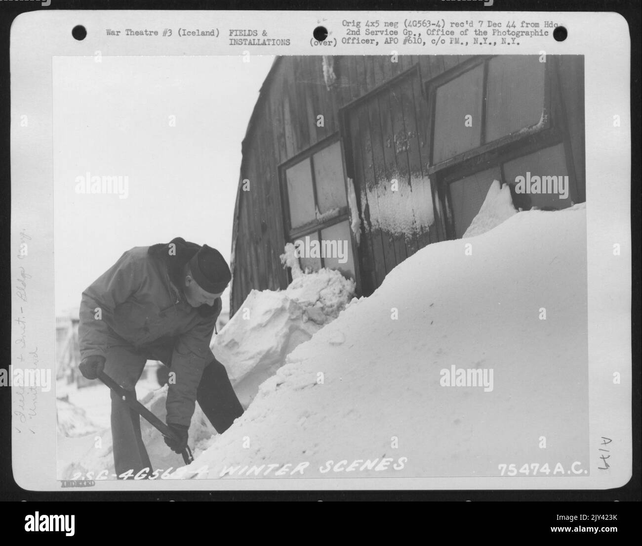 2Nd Service Group Member 'Digs Out' After A Heavy Snowfall At An Air Base Somewhere In Iceland. 14 January 1944. Stock Photo