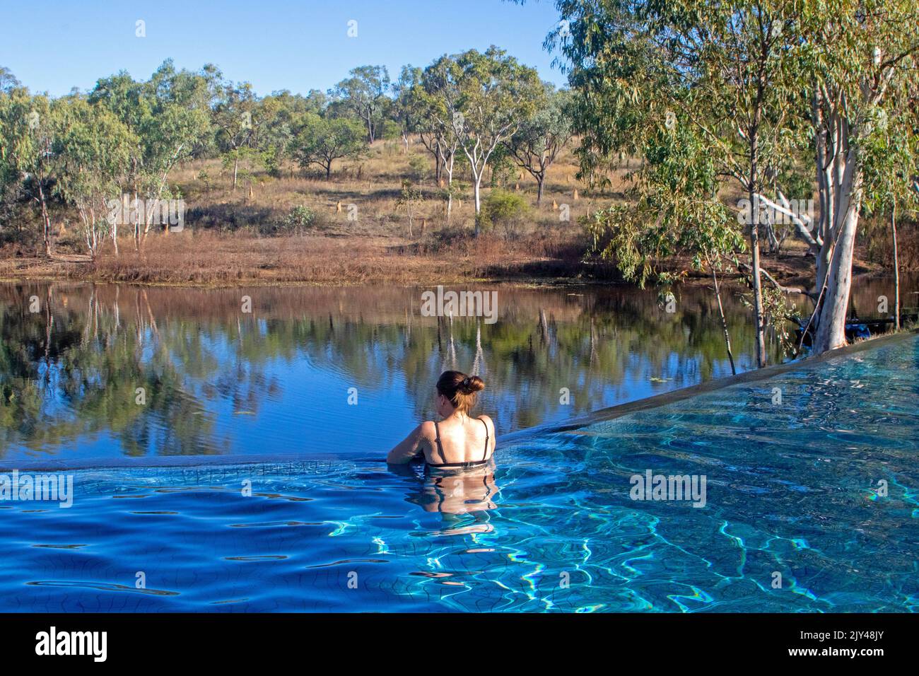 Woman in the infinity pool at Cobbold Gorge Stock Photo