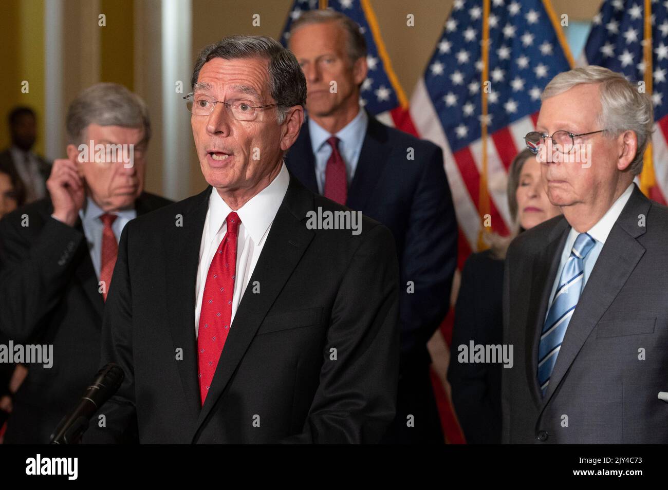 United States Senate Minority Leader Mitch McConnell (Republican of Kentucky), right, United States Senator John Thune (Republican of South Dakota), center back, United States Senator Roy Blunt (Republican of Missouri), left, look on as United States Senator John Barrasso (Republican of Wyoming) offers remarks during the Senate Republicans policy luncheon press conference, at the US Capitol in Washington, DC, Wednesday, September 7, 2022. Credit: Cliff Owen/CNP Stock Photo