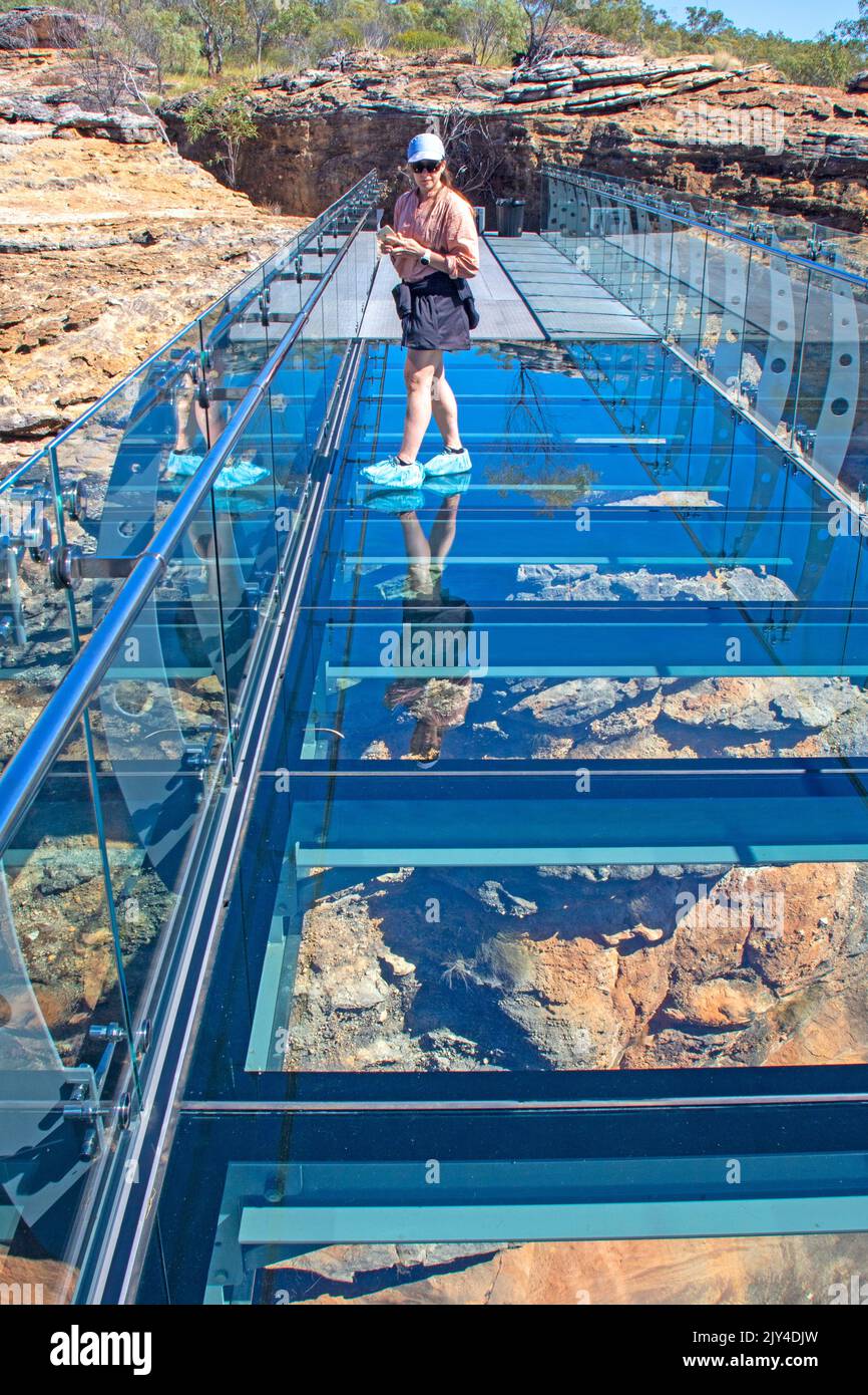 Woman on the glass bridge at Cobbold Gorge Stock Photo