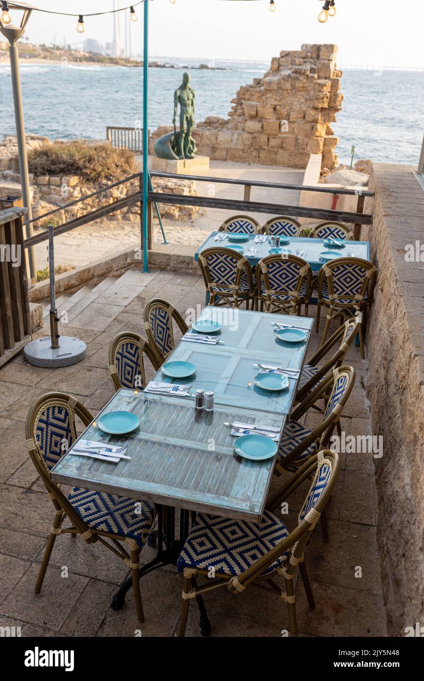 CAESAREA, Israel - August 11 2022, Hellena Restaurant Caesarea Harbor, tables and sea view Stock Photo