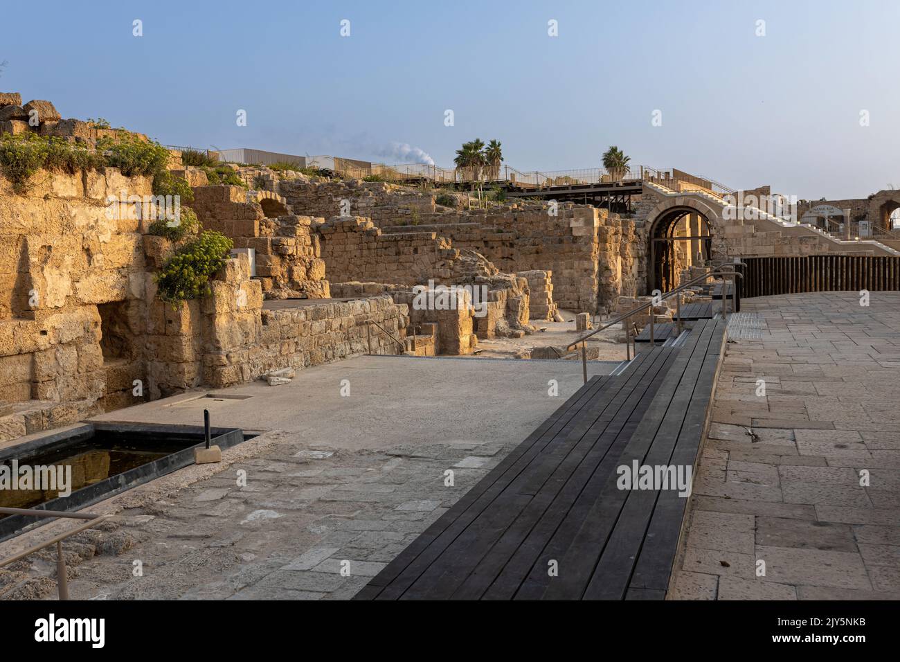 CAESAREA, Israel - August 2022, Roman emperor statue reflecting in a pool, Numerous tourists visit ruins fortress built by Herod the Great near Caesar Stock Photo