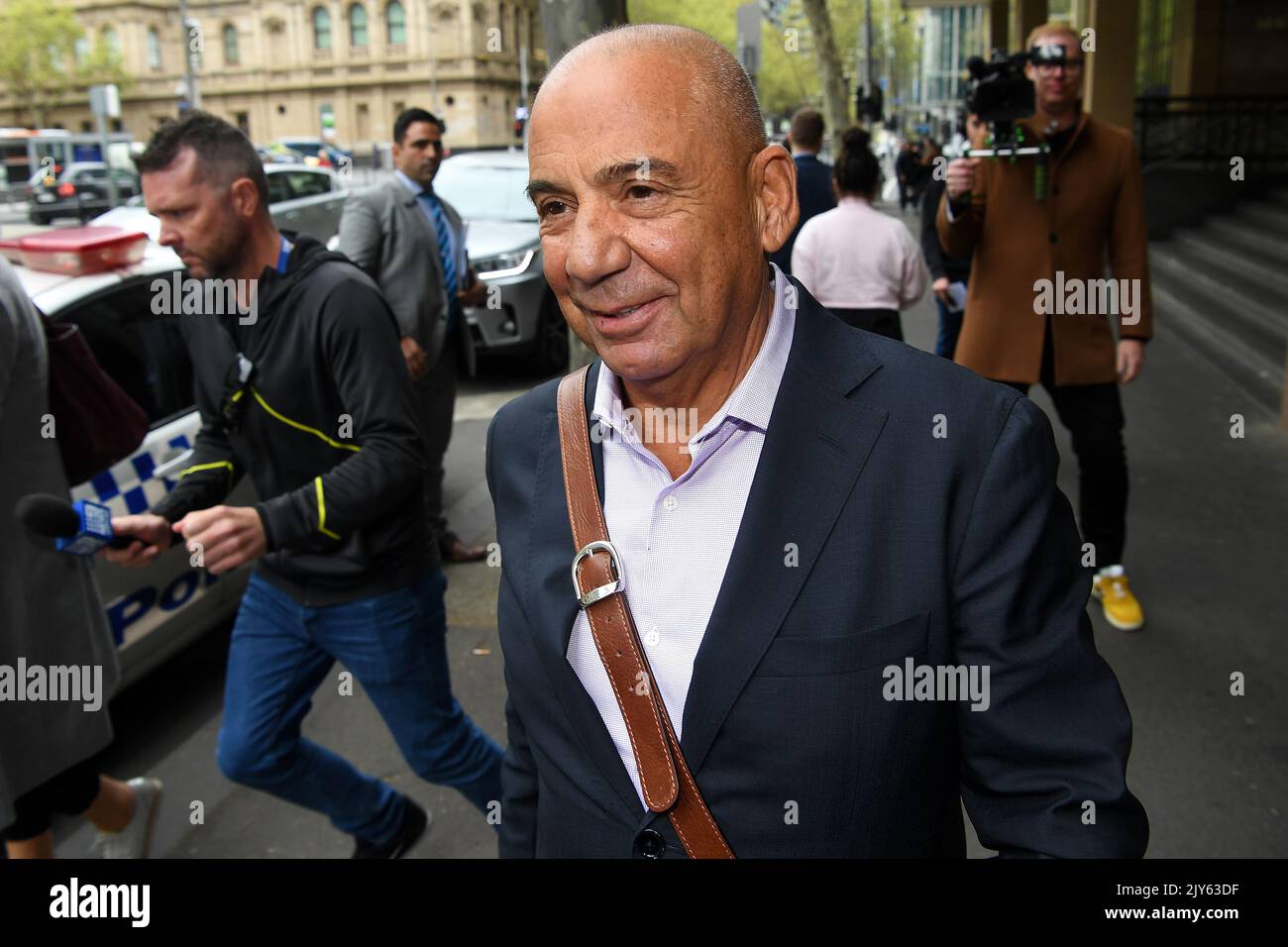 Prestige car dealer Nick Theodossi (centre) departs the Melbourne