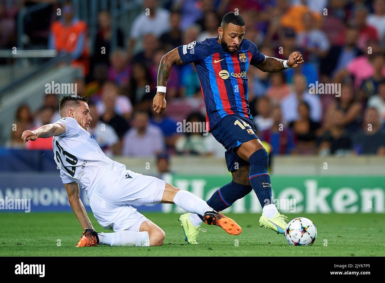 Barcelona. 7th Sep, 2022. Memphis Depay (R) of Barcelona vies with Lukas Kalvach of Viktoria Plzen during the UEFA Champions League Group C match between FC Barcelona and FC Viktoria Plzen in Barcelona, Spain, on Sept. 7, 2022. Credit: Xinhua/Alamy Live News Stock Photo