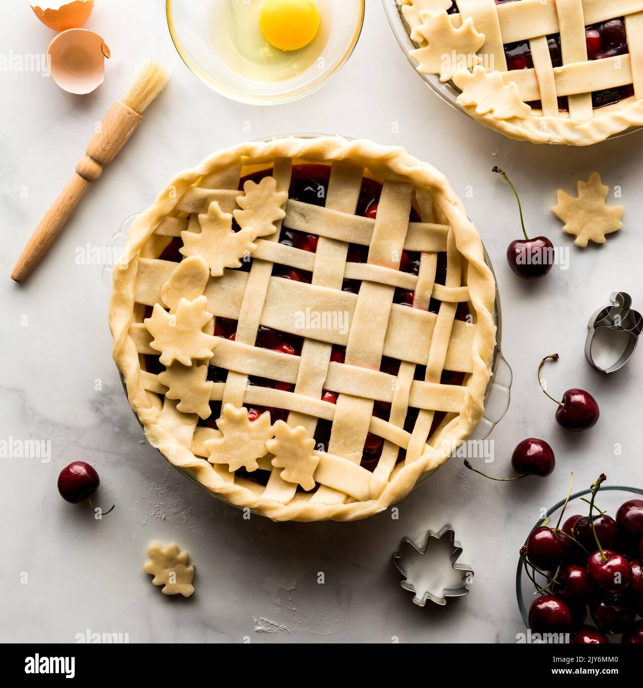 A fall themed unbaked cherry pie ready for egg wash prior to going in