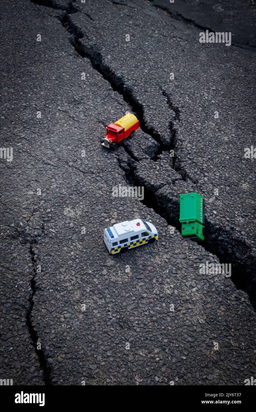 Colourful car toys on a cracked asphalt Stock Photo