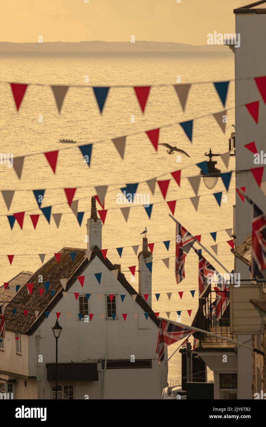Celebration flags during summer events in beautiful coastal town of Lyme Regis, Dorset Stock Photo