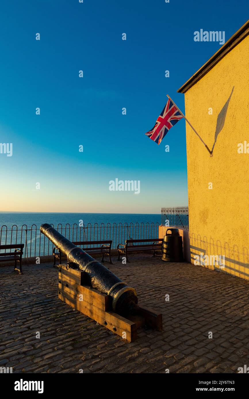 Historic canon and Union Flag on the seafront in beautiful coastal town of Lyme Regis, Dorset Stock Photo
