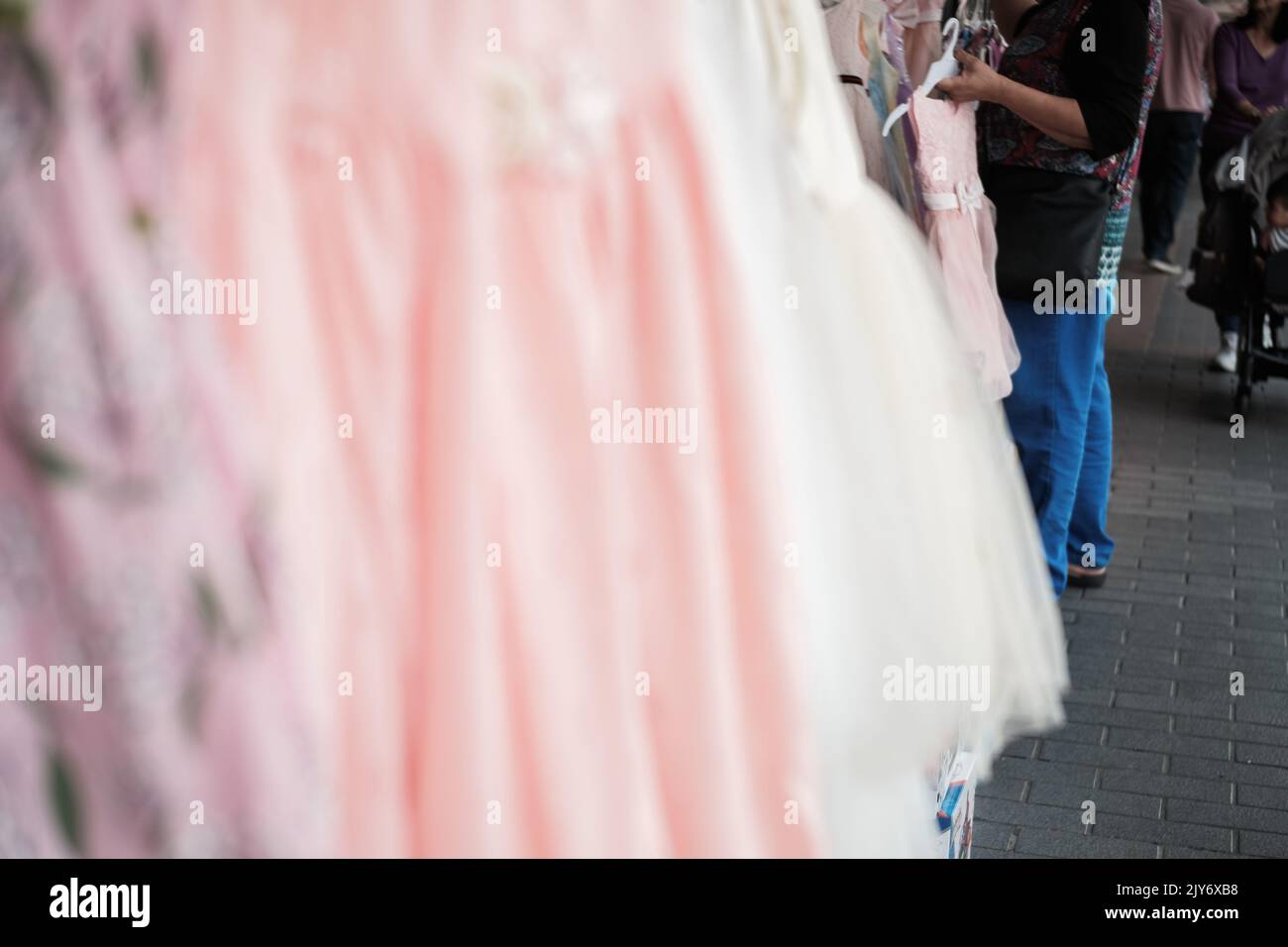 Woman shops for children’s clothes at a retail store on John St
