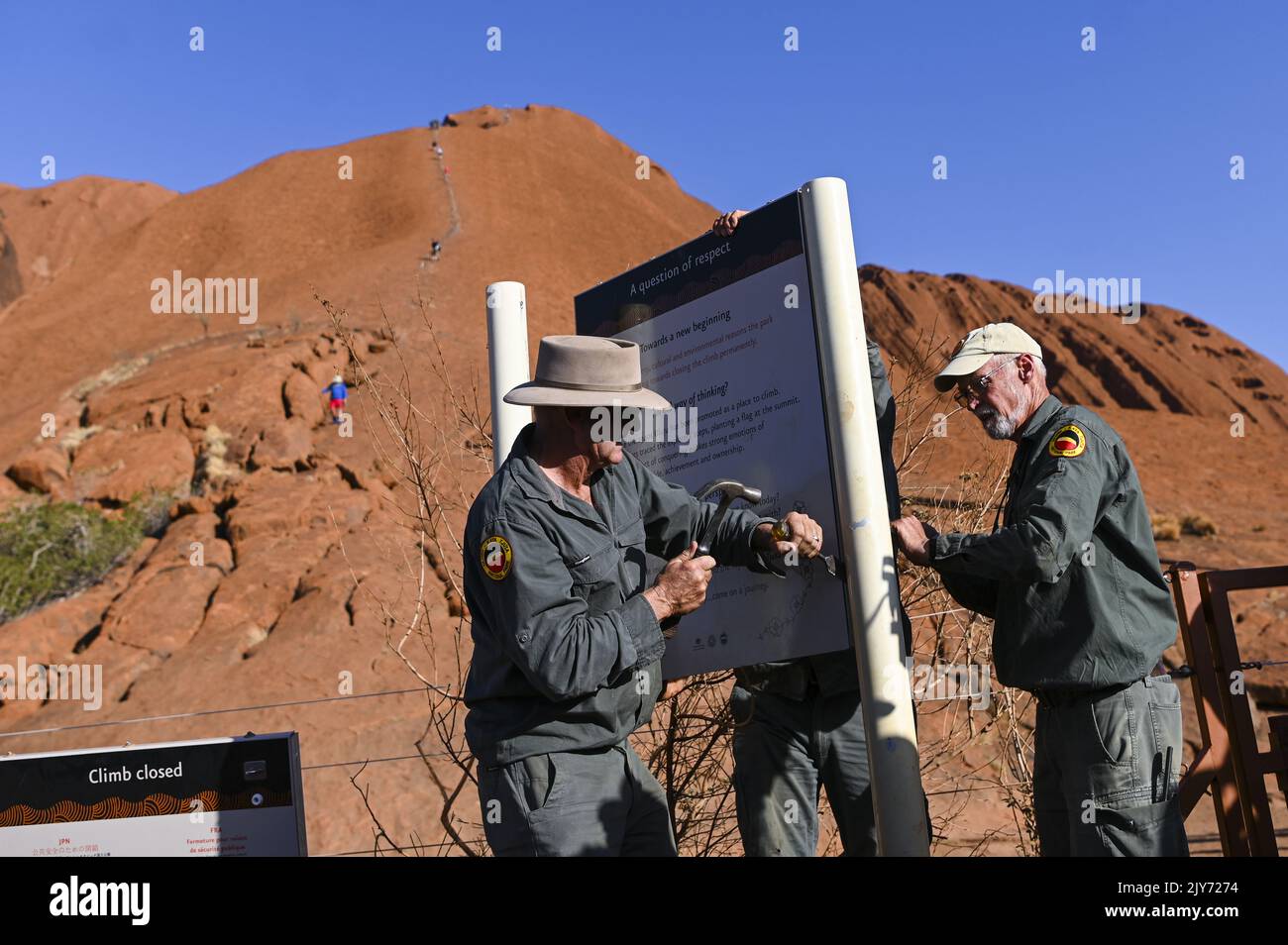 Uluru Rangers Uluru-Kata Tjuta Park rangers take down a sign near the newly installed ...