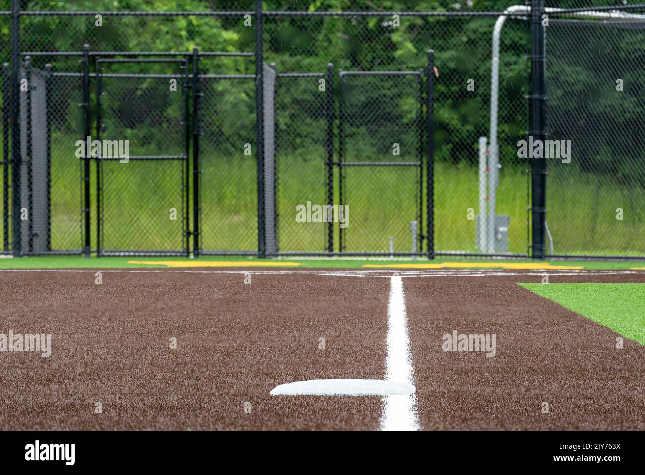 View of high school synthetic turf softball field third base looking