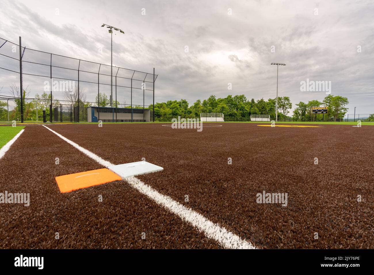 View of high school synthetic turf softball field first base with