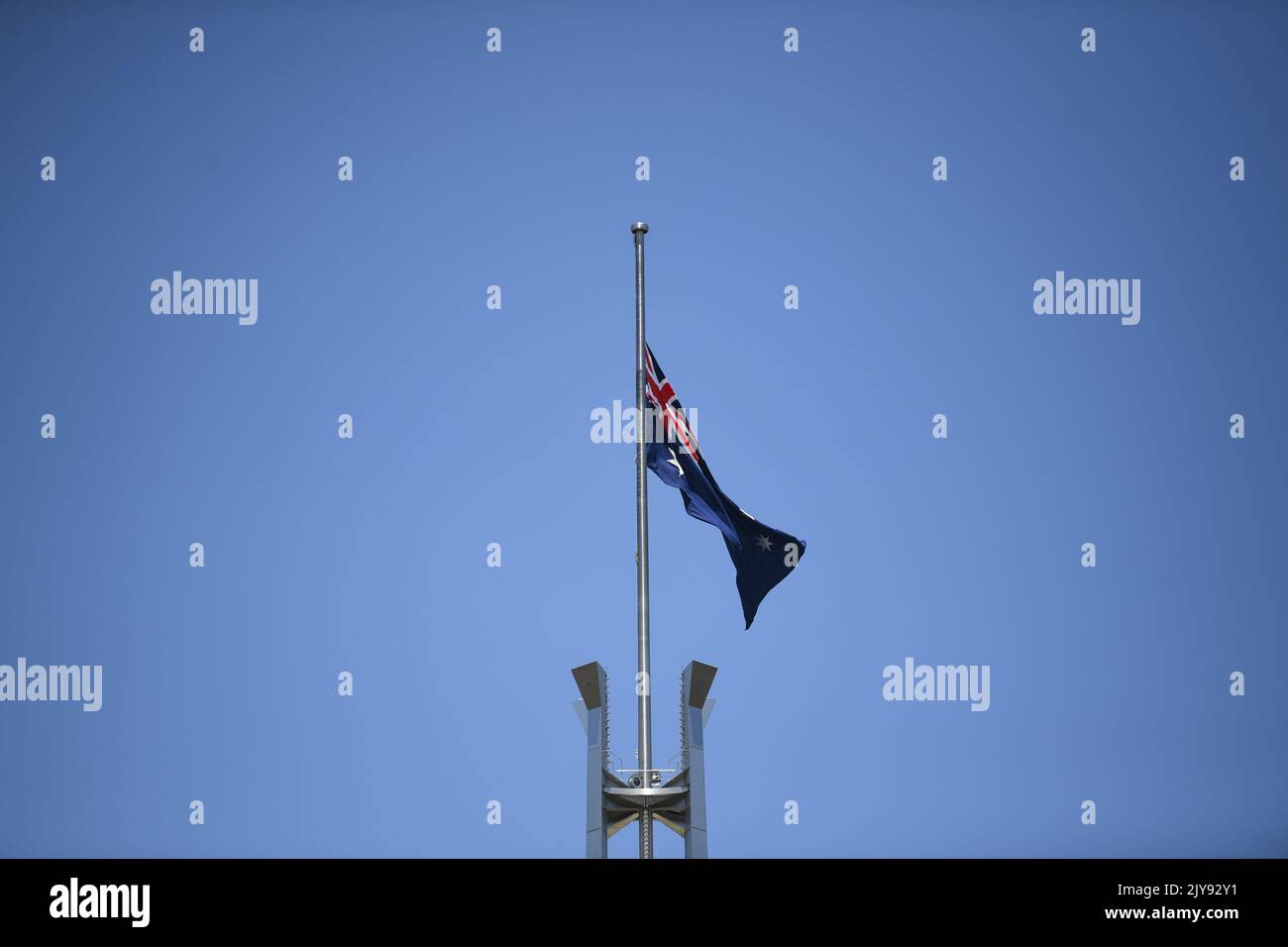 The Australian flag is seen flying at half mast to honour the victims ...