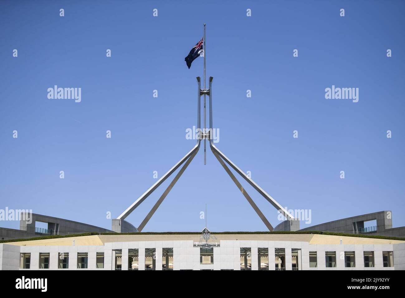 The Australian flag is seen flying at half mast to honour the victims ...