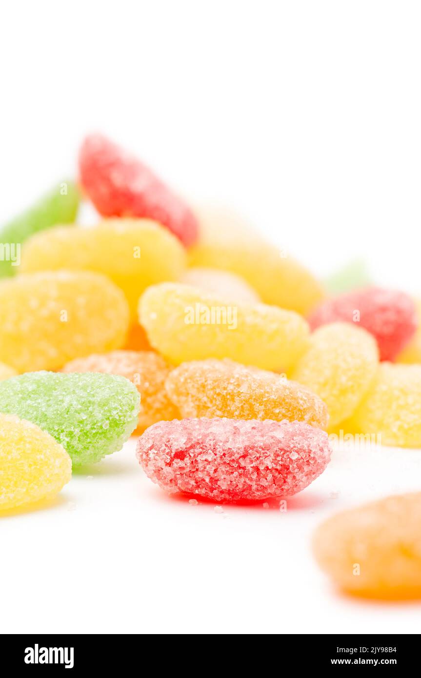 jujube, scattered colorful gummy type of candy confectionery isolated on white background, soft-focus with copy space Stock Photo
