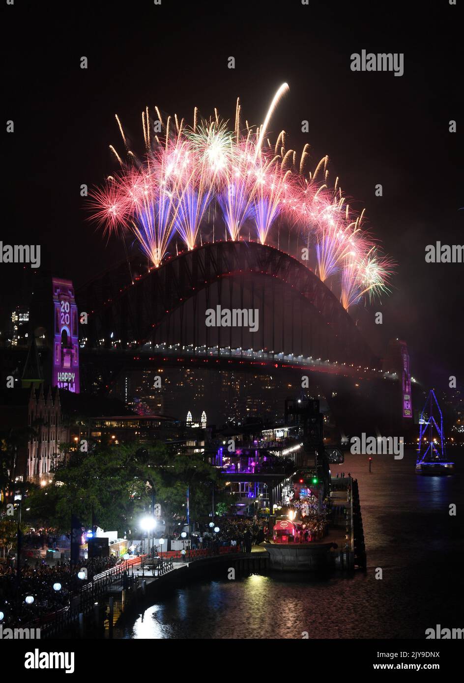 Fireworks explode to in the New Year over the Sydney Harbour Bridge and the Sydney Opera