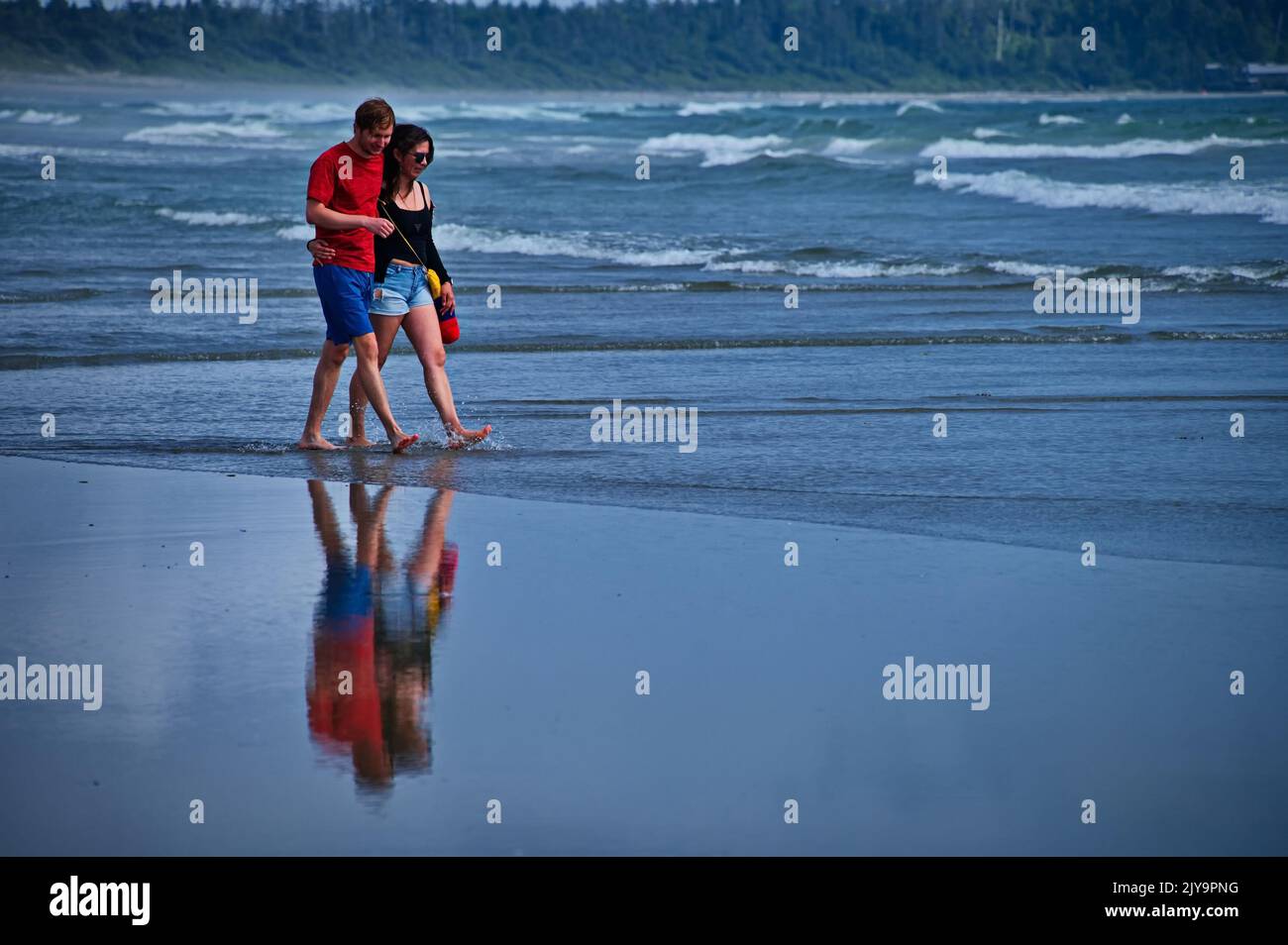 Mature couple walking on beautiful beach in Tofino, Canada Stock Photo
