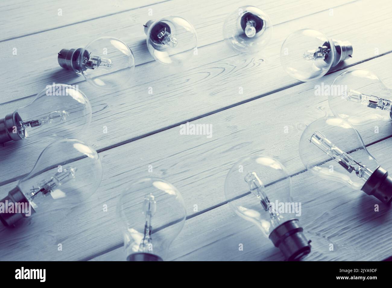 High angle view of light bulbs kept in circular form on floorboard