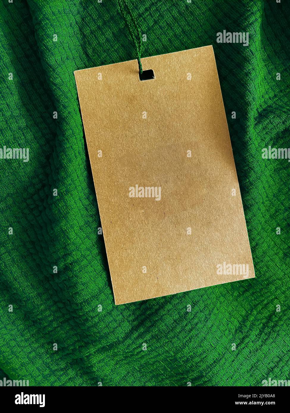 Blank fashion label tag, sale price card on luxury fabric background, shopping and retail